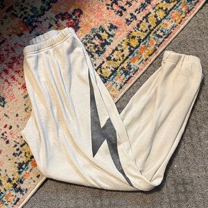 Aviator Nation Cream Track Pants with Black Lightning Bolt